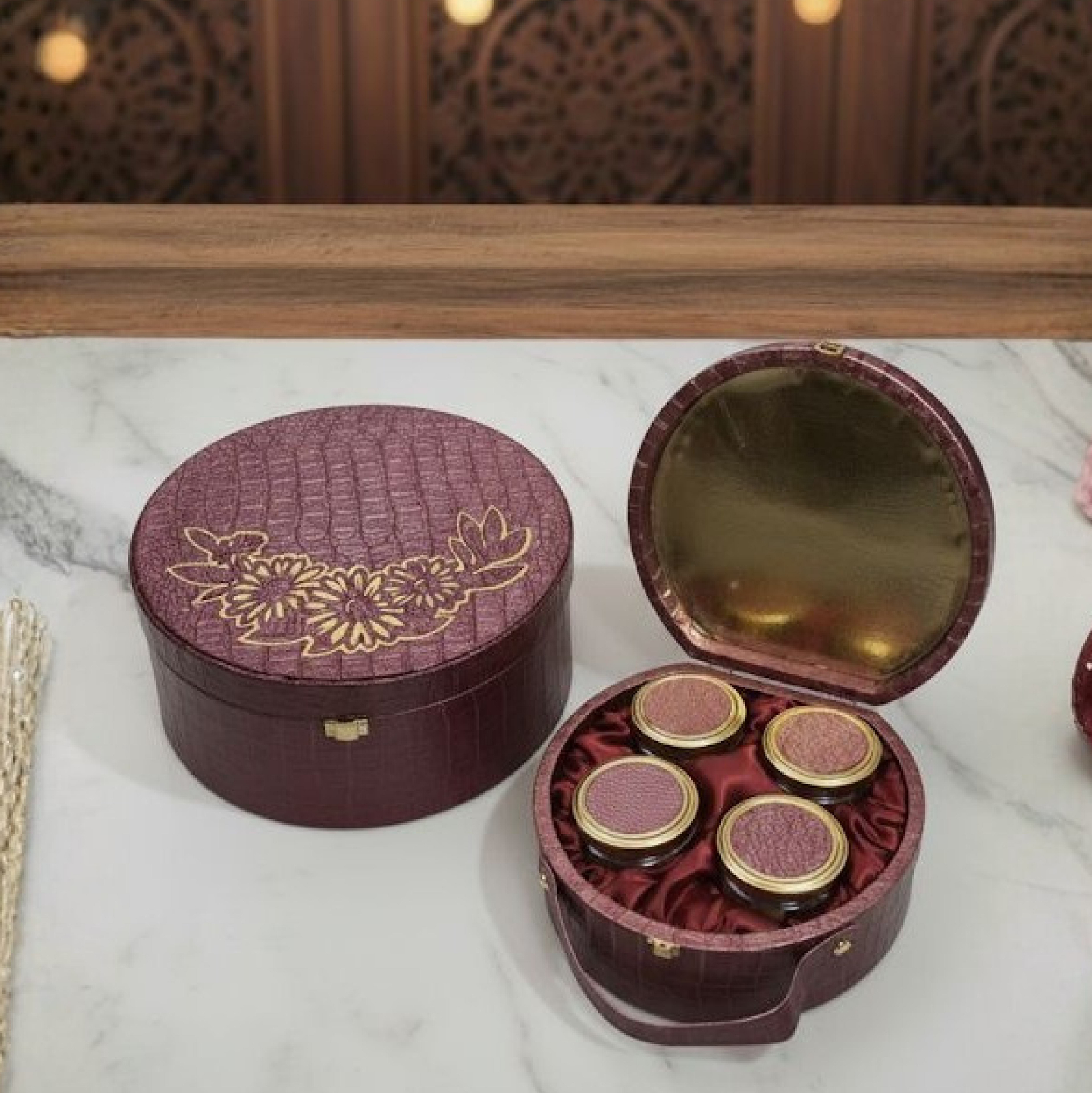 Open Valvate Royal hamper with mirrored gold interior and four dry fruit jars in satin lining