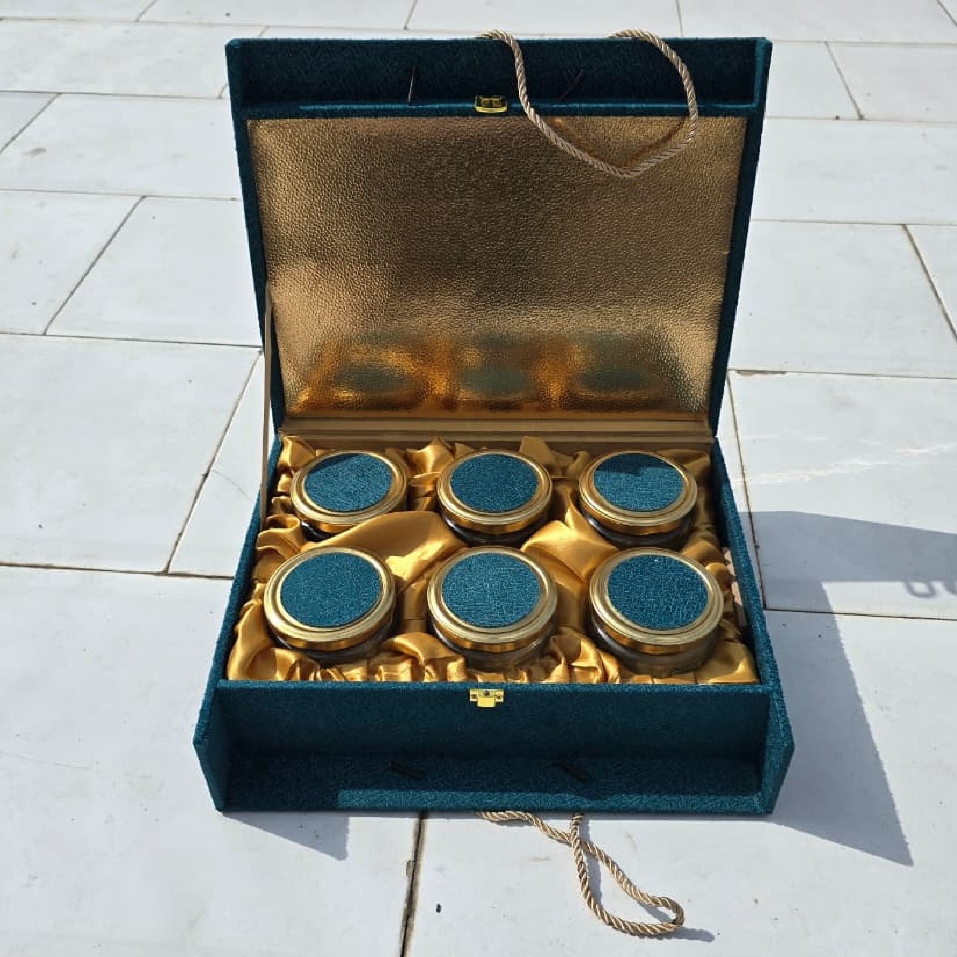 Closed teal velvet Special Radhe Delight hamper box with gold foil floral border and rope handles