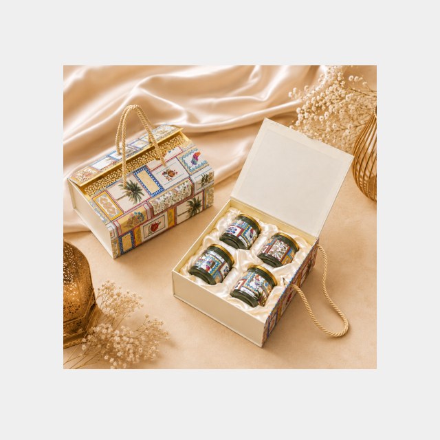 Cream pichwai-print Diwali carry box with handle holding four dry fruit jars