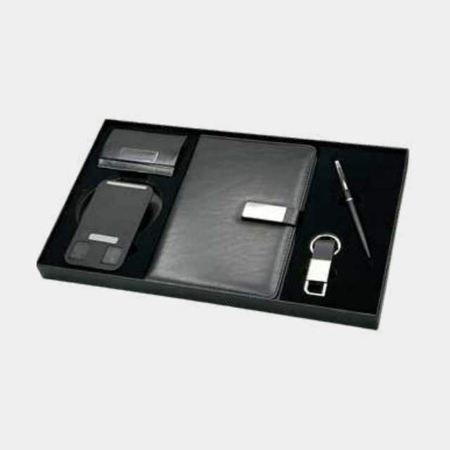 All-black executive gift set with power bank, card holder, metal pen and keychain in a fitted tray