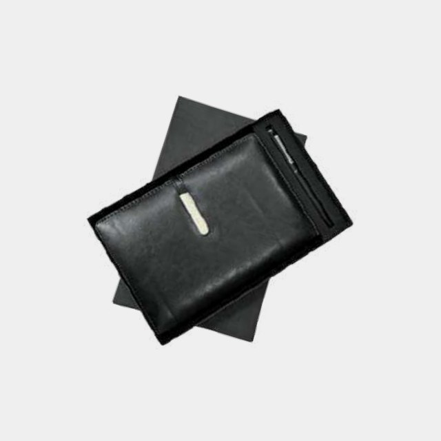 Black leather A5 notebook with a metal pen on a dark presentation board