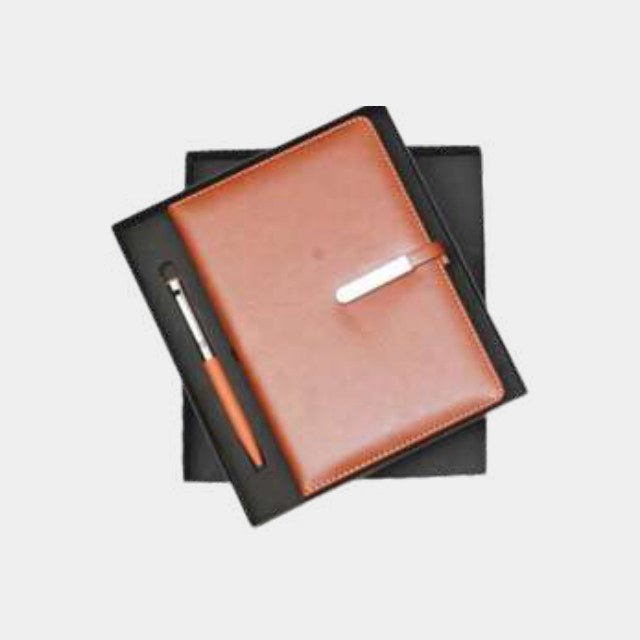 Tan leather A5 notebook with metal clasp closure and an orange-barrel metal pen