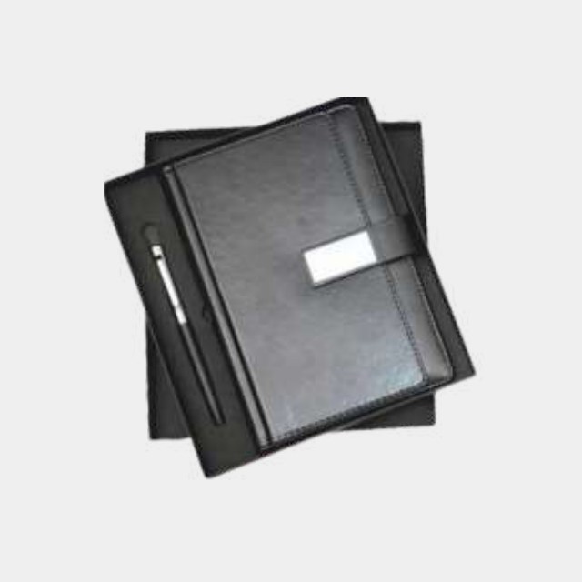Charcoal leather A5 notebook with a brushed metal logo plate and matching metal pen