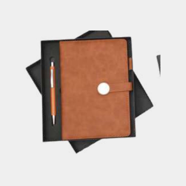 Tan leather notebook with a round magnetic clasp closure and a wooden pen