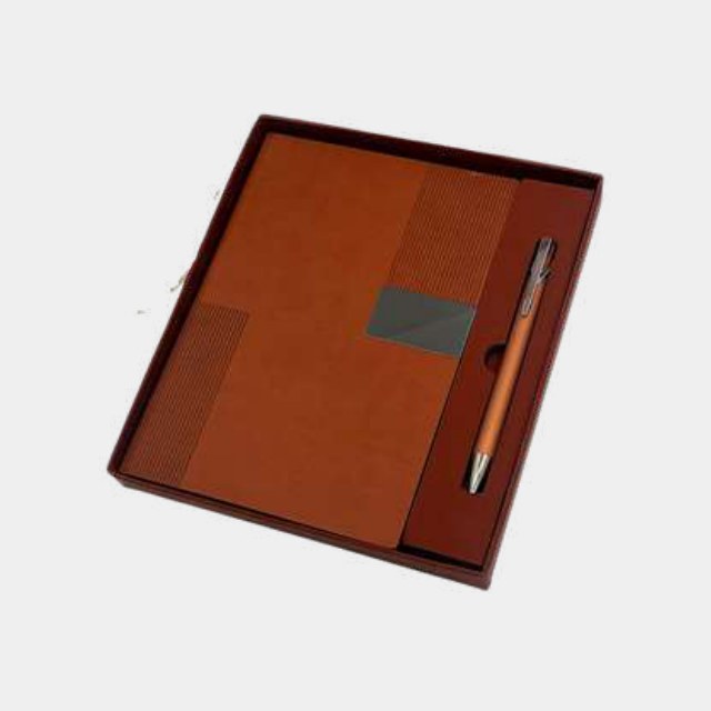 Tan PU notebook with grey metal logo plate and metal pen in a wooden presentation tray