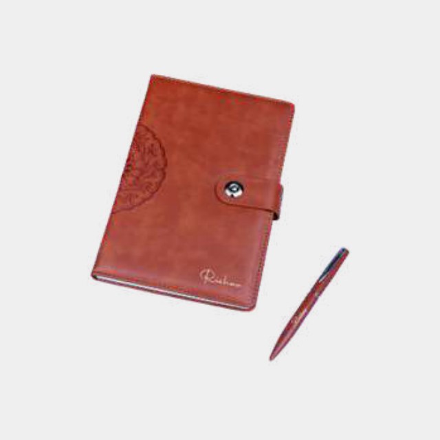 Tan leather notebook with an embossed circular crest, snap closure and burgundy metal pen