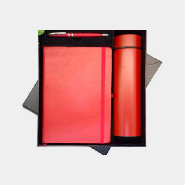 Red notebook with colour-matched insulated bottle and metal pen in a fitted tray
