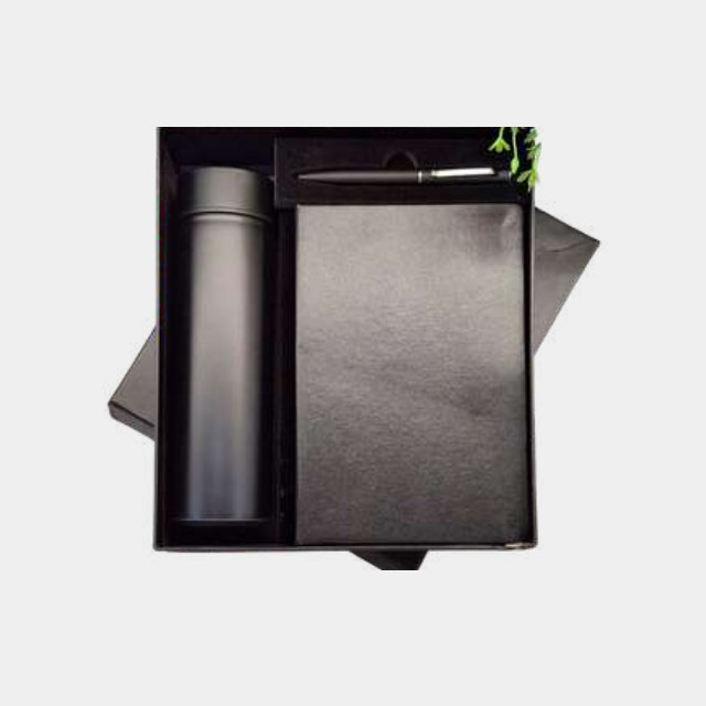 Charcoal notebook with dark grey insulated bottle and metal pen in a fitted tray