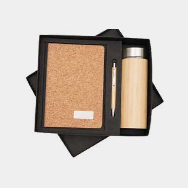 Cork-cover notebook with bamboo-wrapped bottle and turned wooden pen in a dark tray