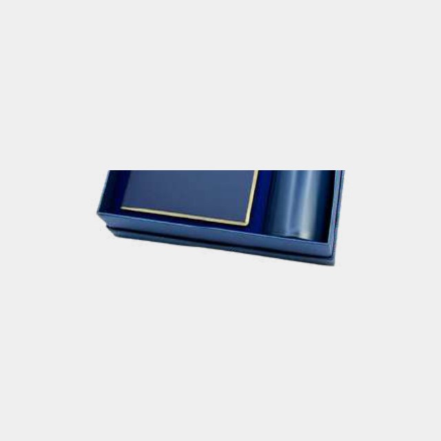 Navy notebook with gold page edging and a matching navy insulated bottle