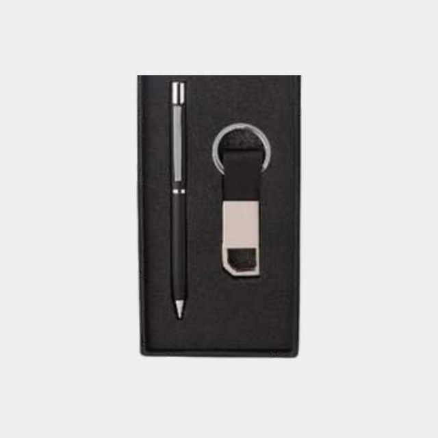 Slim metal pen with a leather-strap keychain on a fitted black card