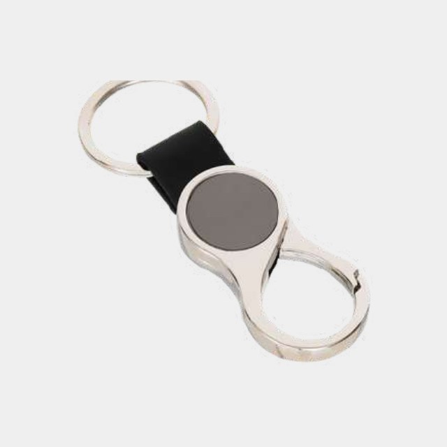 Chrome figure-eight keychain with a black leather strap and circular engraving disc