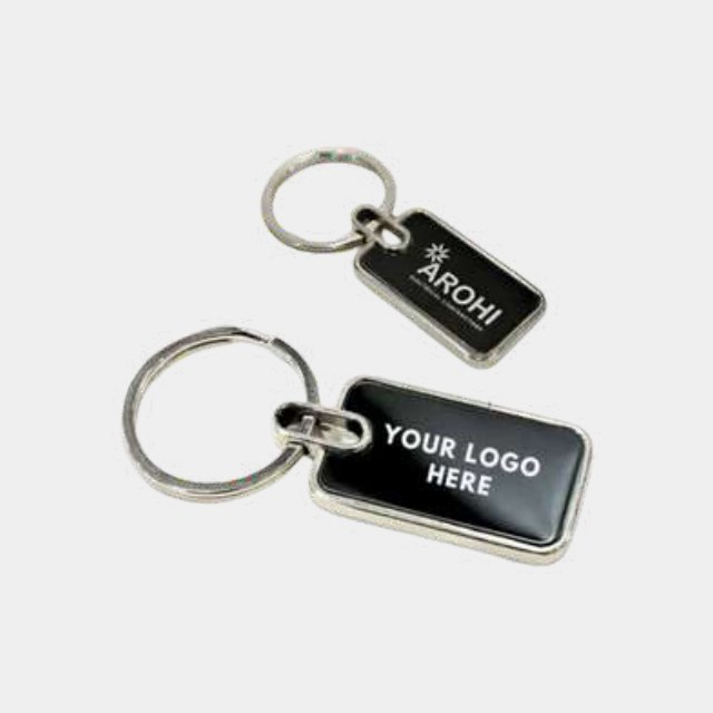 Mirror-finish metal keychain with a recessed black panel for a colour logo