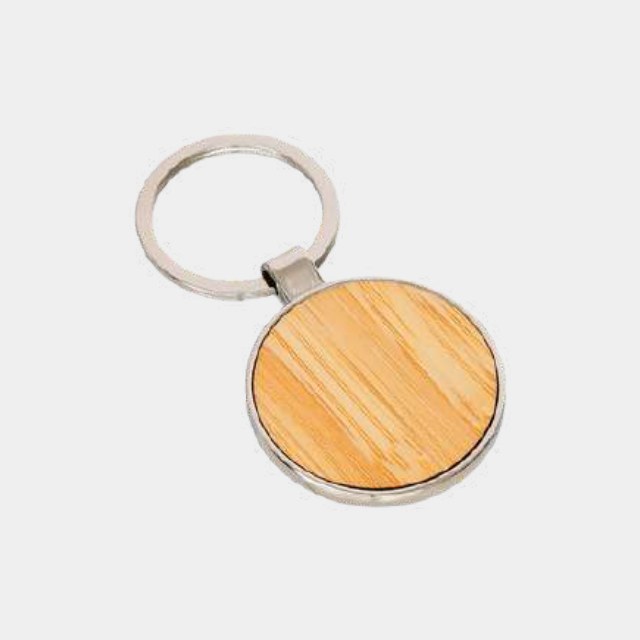 Round light-wood keychain with a metal collar and laser-engraved face