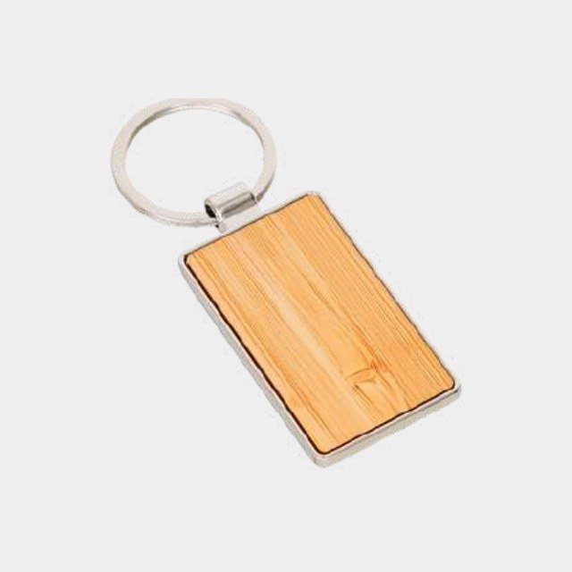 Rectangular bamboo keychain with a metal ring mount and engraved face