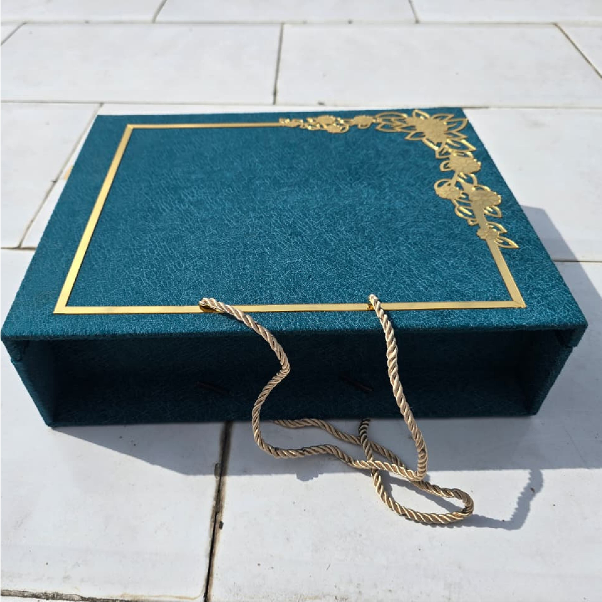 Open Special Radhe Delight hamper with gold satin interior and six teal jars of dry fruits and chocolates
